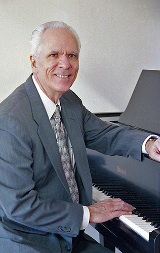 Photo of JBA at the piano